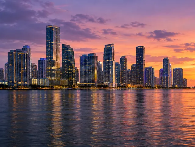 The Brickell skyline glowing across Biscayne Bay at dusk